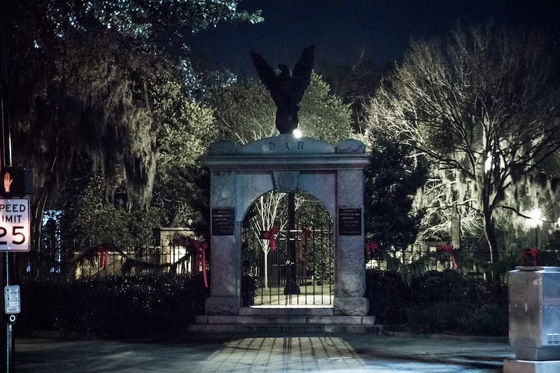 Night time at the gate arch entrance of Colonial Park Cemetery in Savannah, Georgia, a haunted stop on the Savannah Terrors ghost tour by US Ghost Adventures