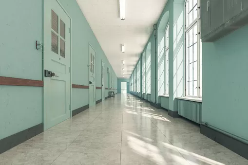 photo shows a hospital hallway with mint green walls and locking doors.
