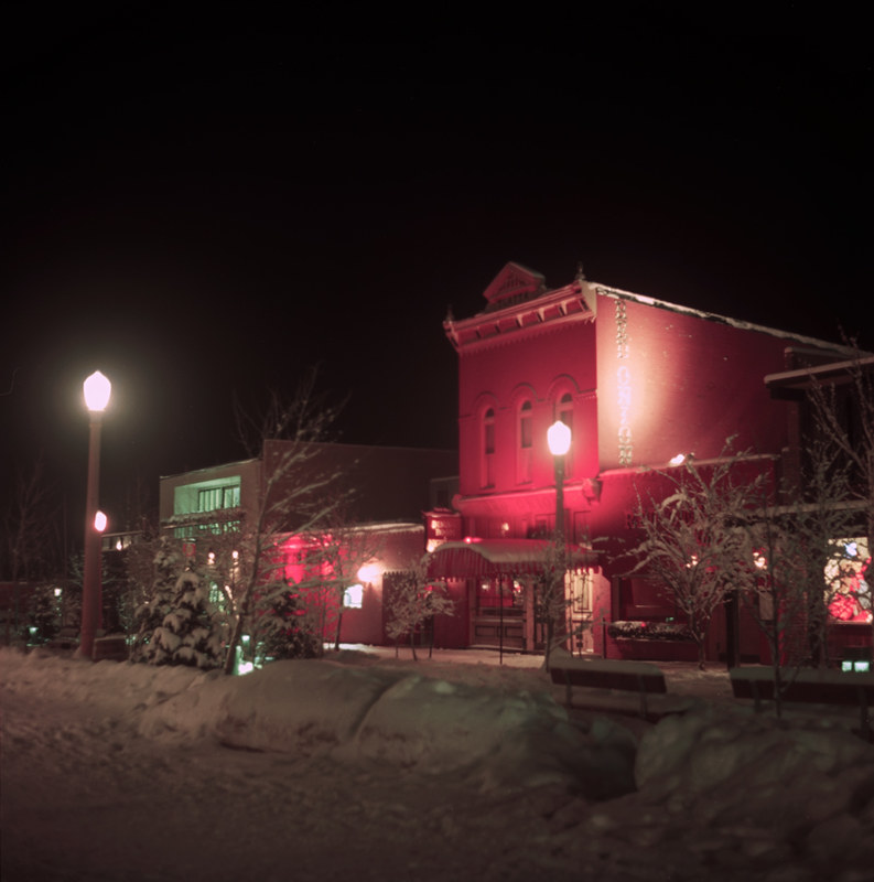 photo shows the red onion
 lit up at night with a blanket of snow covering the area. 