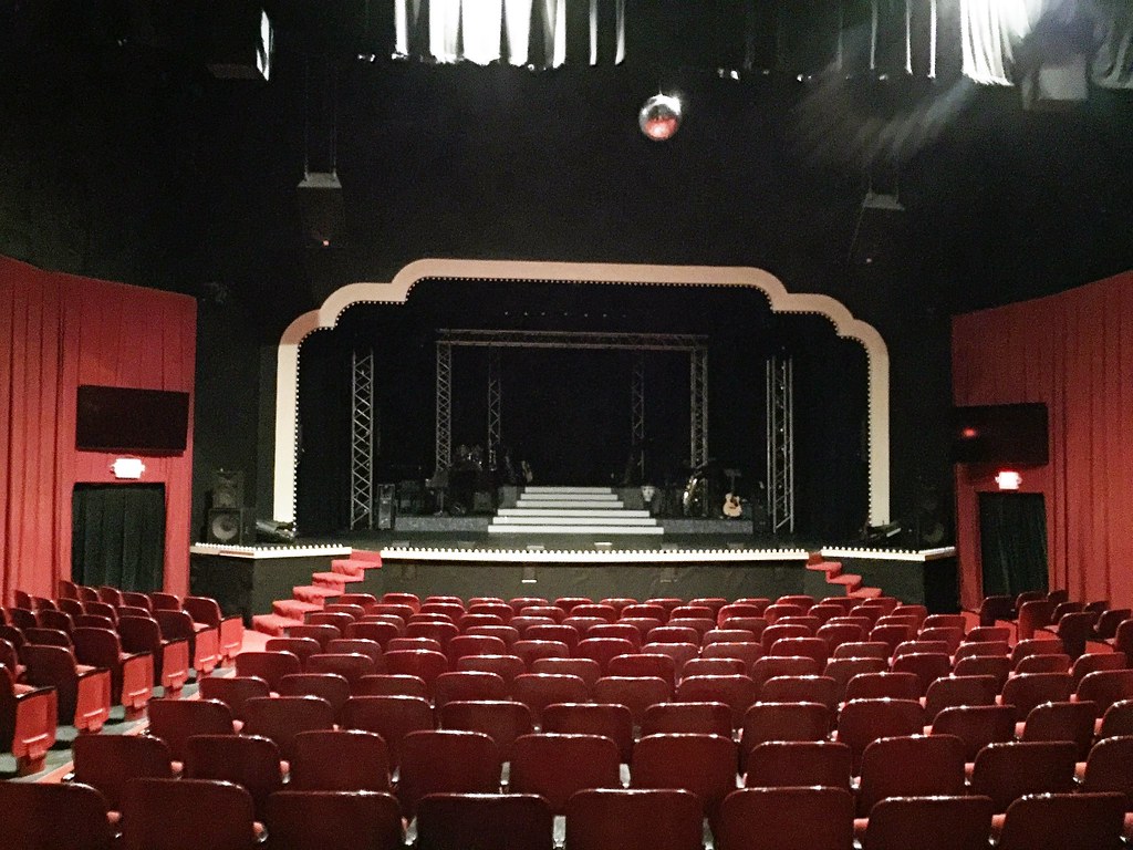 photo shows the stage in the savannah theatre, with red seats and black paint 