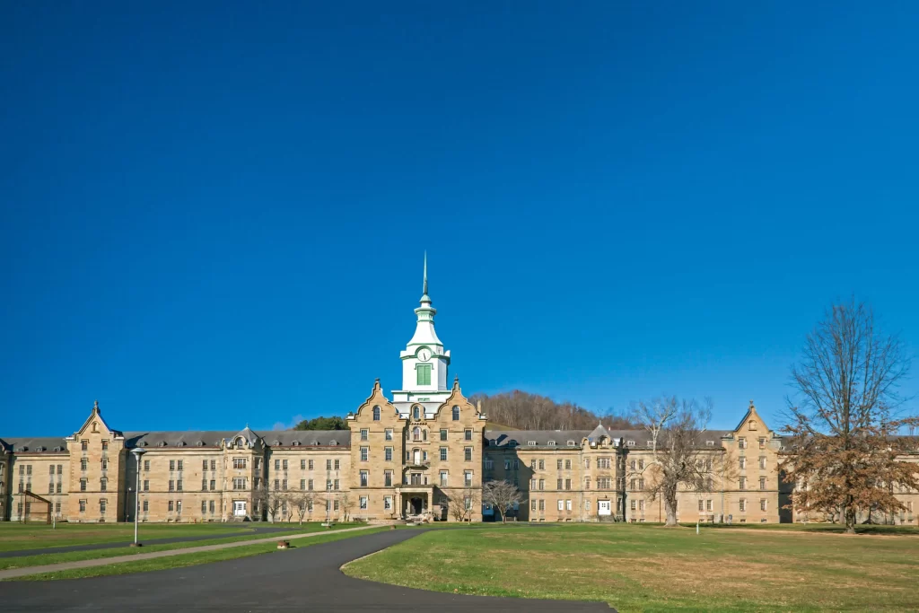 photo shows the whole front of the trans allegheny lunatic asylum. its sprawling with blue skies behind it 