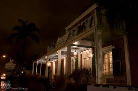 photo shows the whaley house at nighttime lit up by the porch light