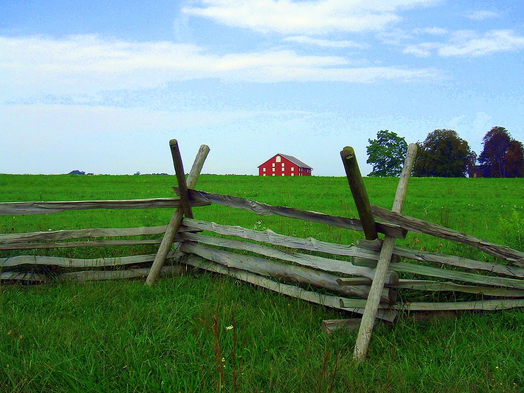 photo shows a red barn behind a wooden fence at gettysburg