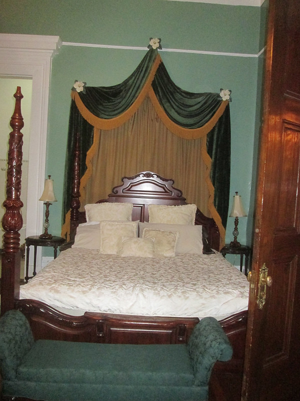 Magnolia Mansion. Green themed Victorian bedroom. 