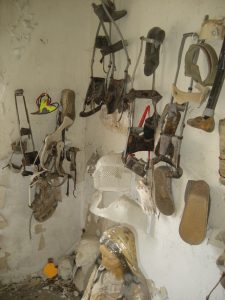 A collection of foot braces hanging from a wall