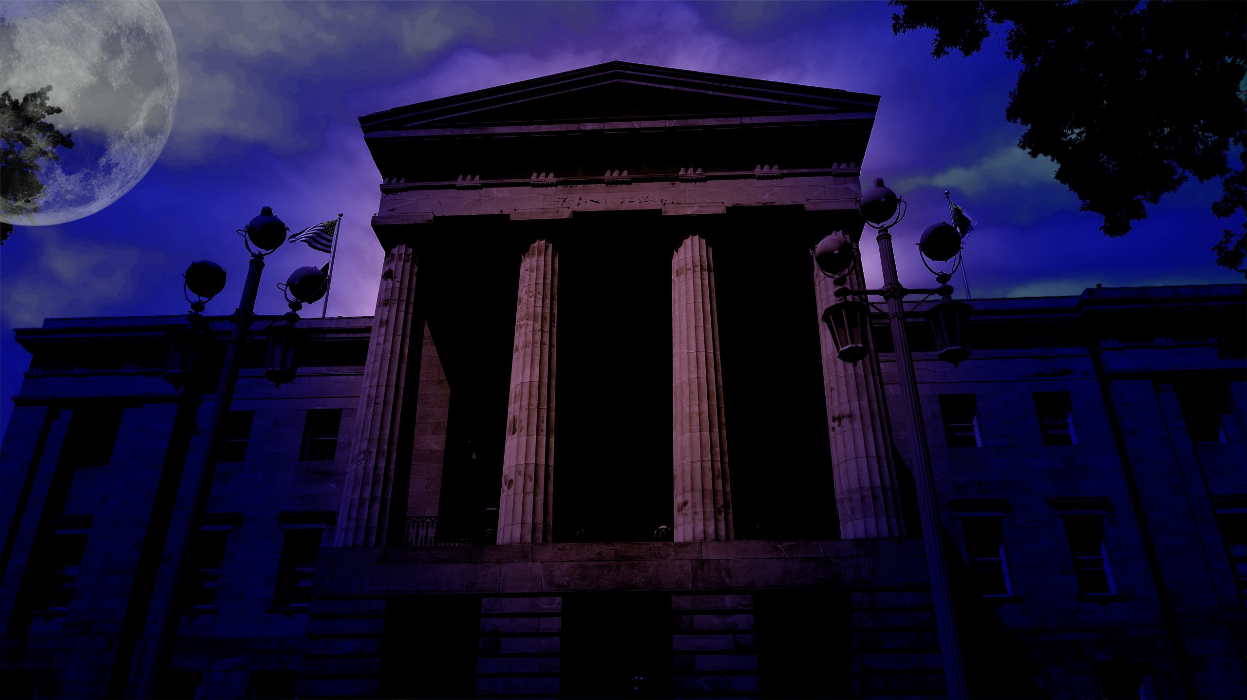 The North Carolina State Capitol Building at night underneath a full moon, haunted site in Raleigh, NC and on the Raleigh Ghosts Haunted Tour.