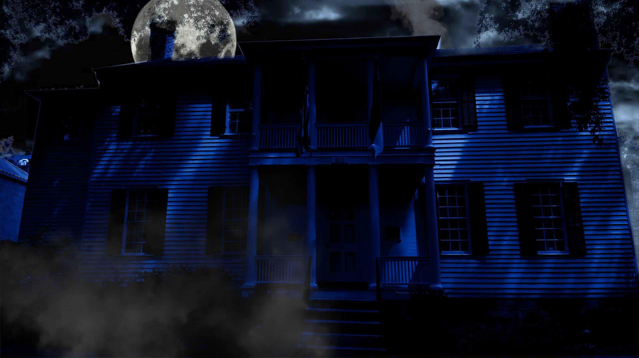 The White Holman House at night underneath a full moon, haunted site in Raleigh, NC and on the Raleigh Ghosts Haunted Tour.