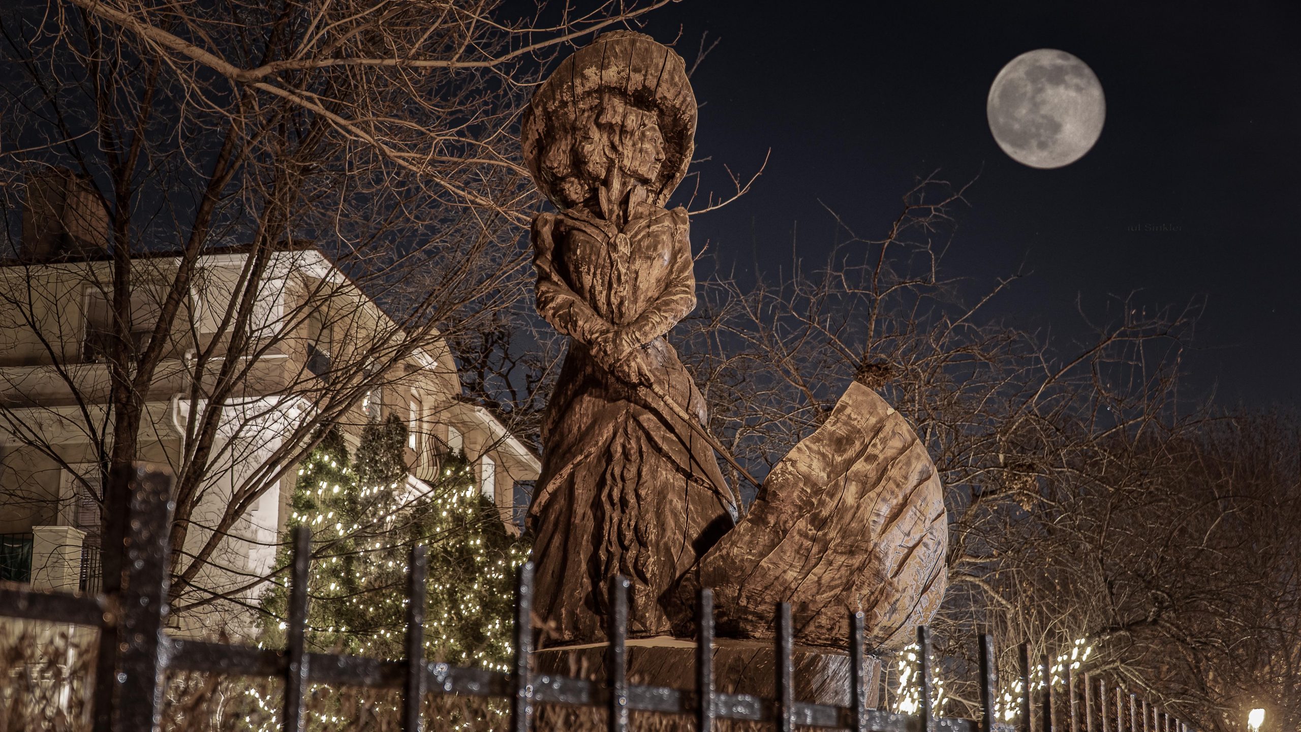 The Madame Clifford's Statue at night under the moon in St. Paul, MN and haunted location on the Twin City Ghosts haunted tour