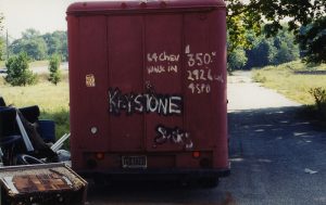 Centralia. Image shows an abandoned, bright-red trash bin sprayed with graffiti 