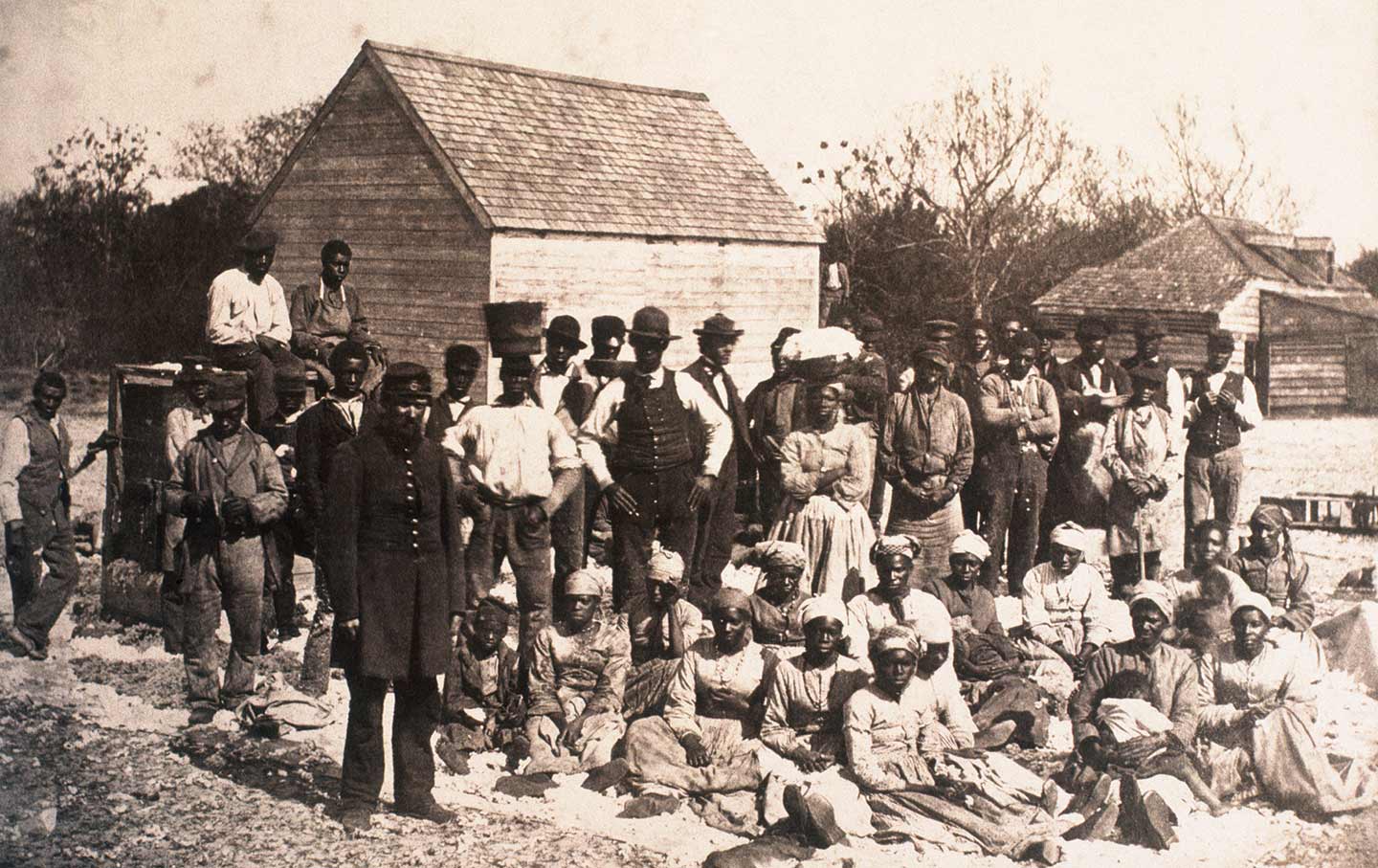 Photograph From 1862. A group of African Americans in front of shacks