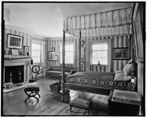 photo shows an old room with an opulent bed and decor 
