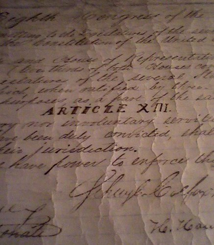 A crumpled piece of paper that read XIII, among other cursive writing.