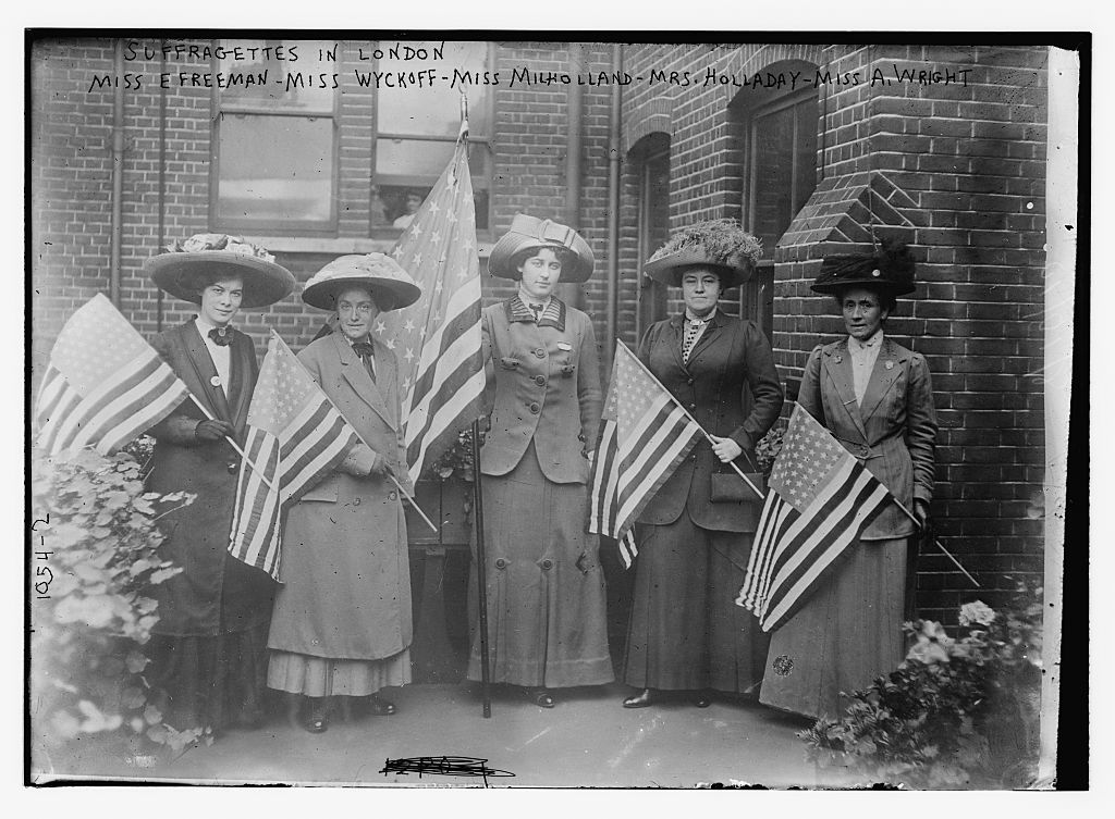 photo shows a photo of women holding american flags