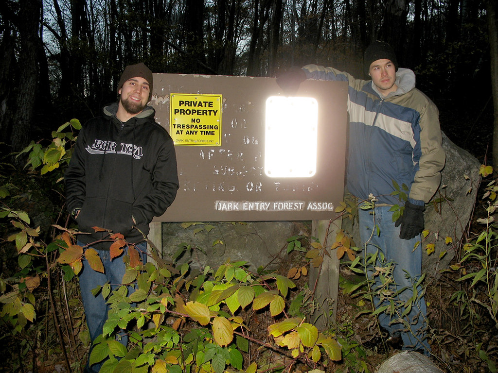 Dudleytown. Two men in hoodies stand near a no trespassing sign