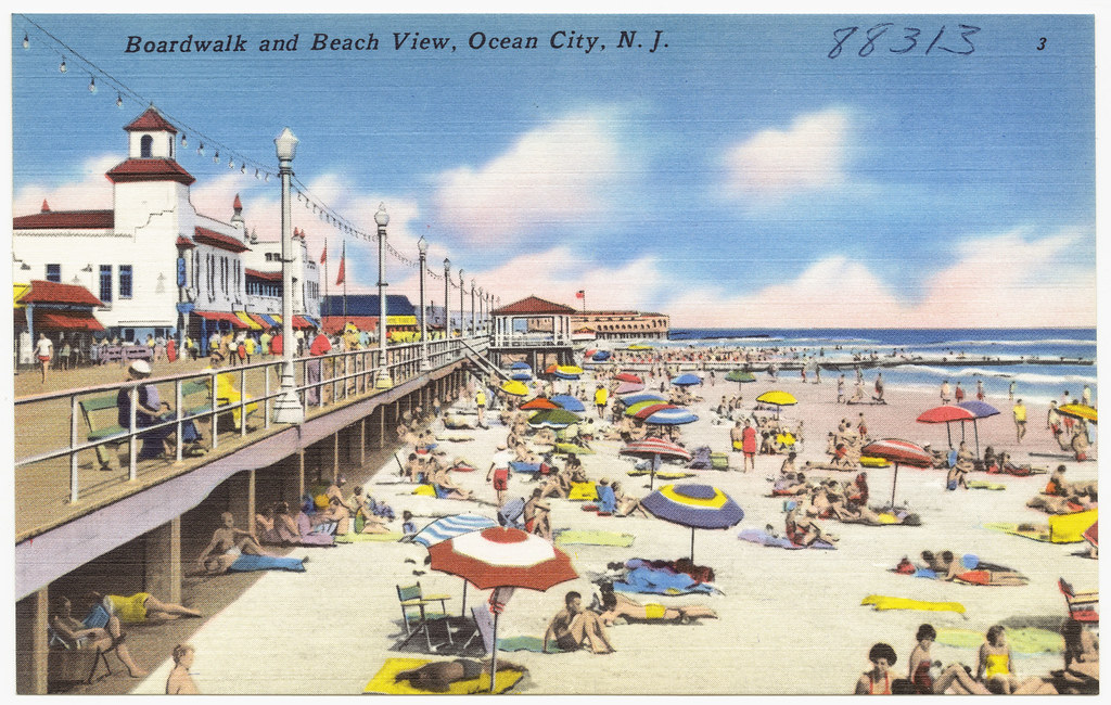 A postcard image of the boardwalk in Ocean City with a display of the Ocean City Mansion