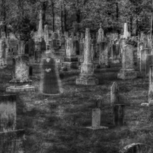 black and white photo of ghosts in a cemetery